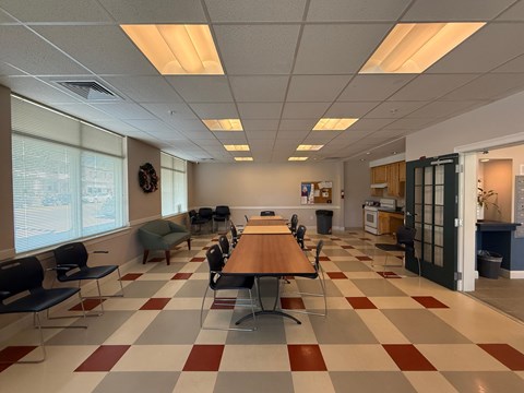A conference room with a long table and chairs.
