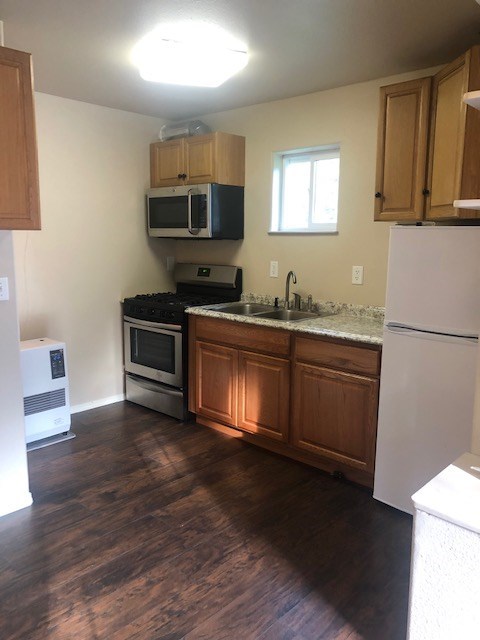 a kitchen with a stove microwave and a sink