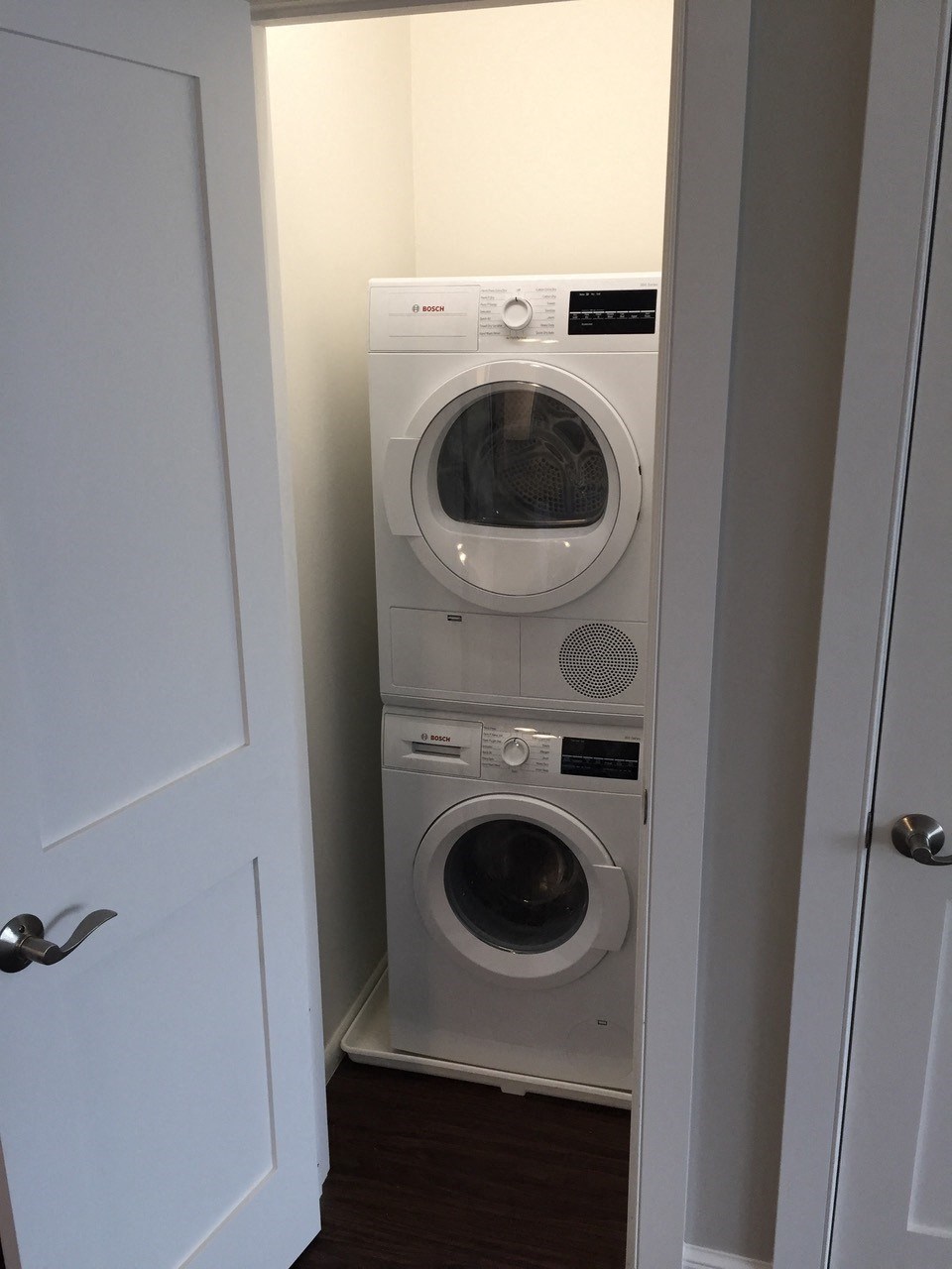 a front loading washer and dryer in a laundry room