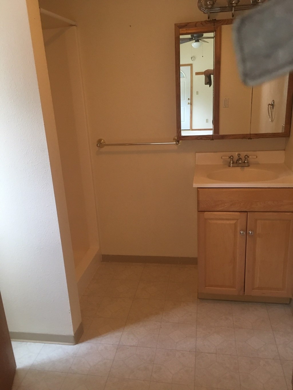 an empty bathroom with a sink and a mirror