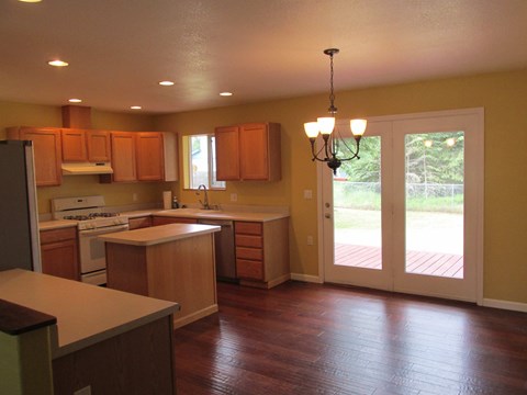 A kitchen with wooden cabinets and a white refrigerator.