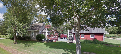 A tree in front of a house.