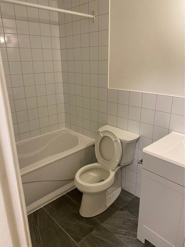 a bathroom with a toilet and a bath tub