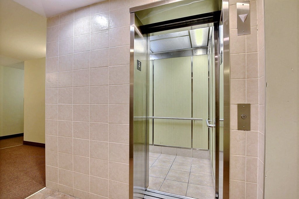 a bathroom with a shower and a glass door