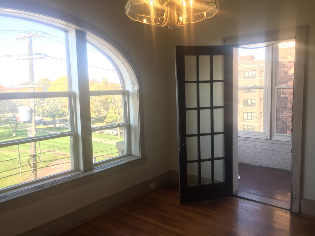 A room with a large window and a door.
