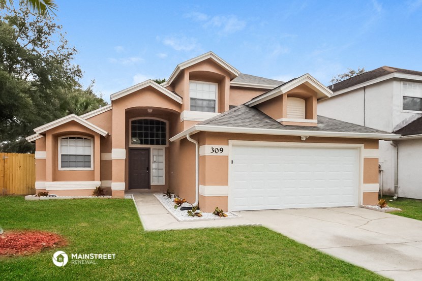 a house with a yard and a white garage door