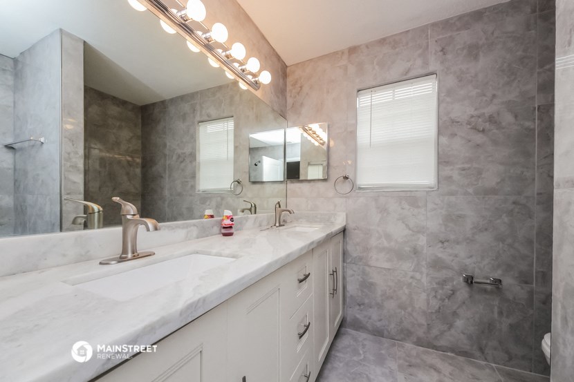 a bathroom with a sink and a mirror and a shower