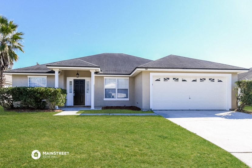 a white house with a lawn and a garage door