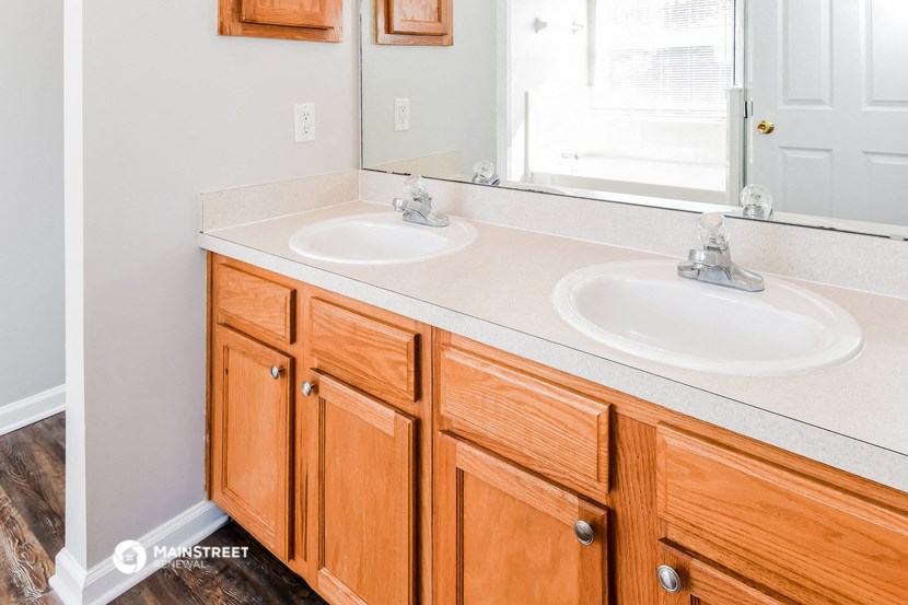 a bathroom with two sinks and a mirror