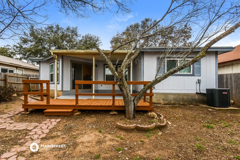 a small porch with a tree in front of a house
