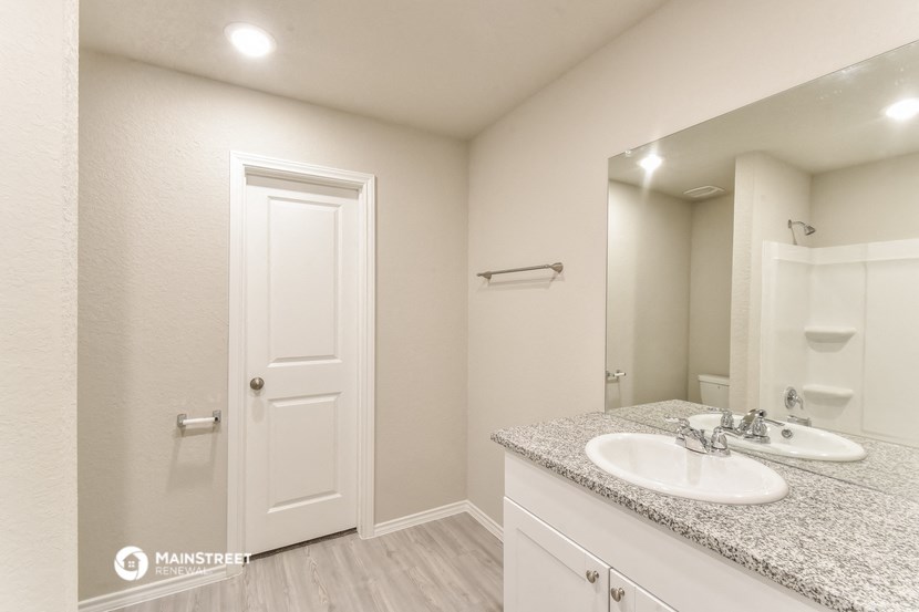 a bathroom with two sinks and a large mirror