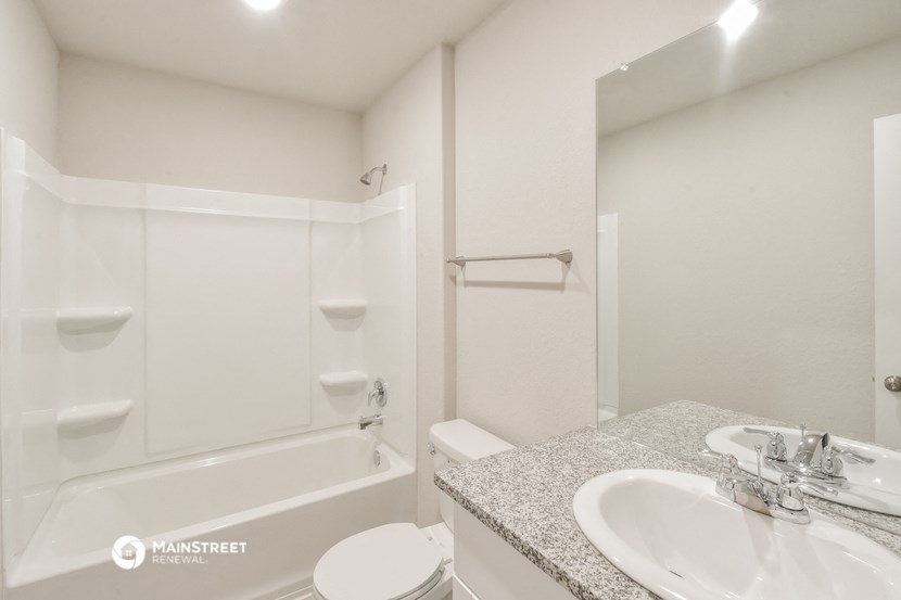 a bathroom with a sink and a bath tub and a mirror