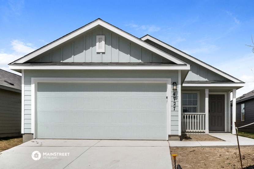 a white garage door in front of a house
