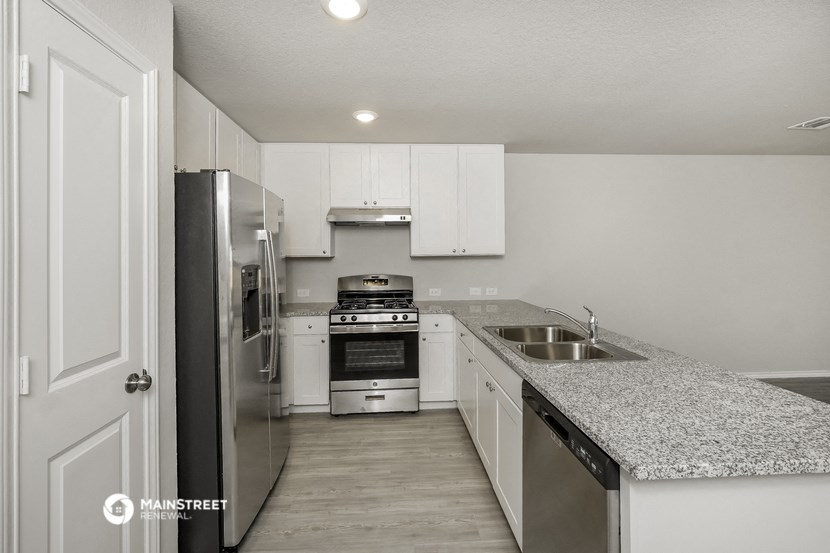 a kitchen with granite counter tops and stainless steel appliances