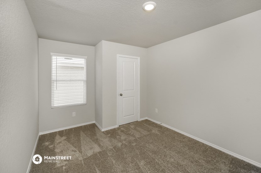 the interior of a room with carpet and a white door