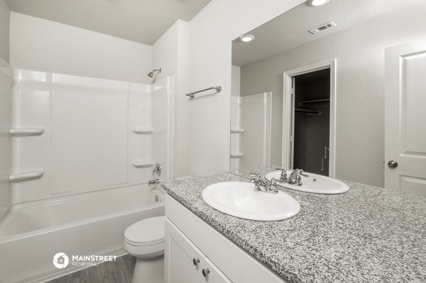 a bathroom with a sink and a shower and a toilet