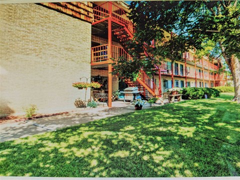 A red staircase is outside a building.