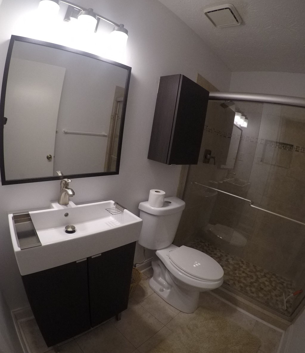 a small bathroom with a toilet sink and shower
