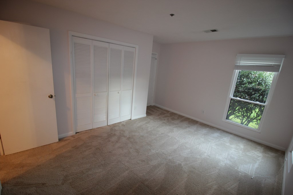 an empty room with a door and a window