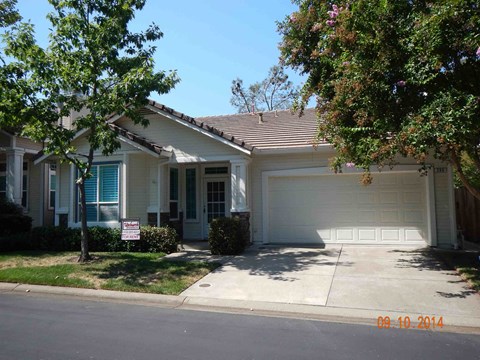 a white house with a driveway and a white garage door