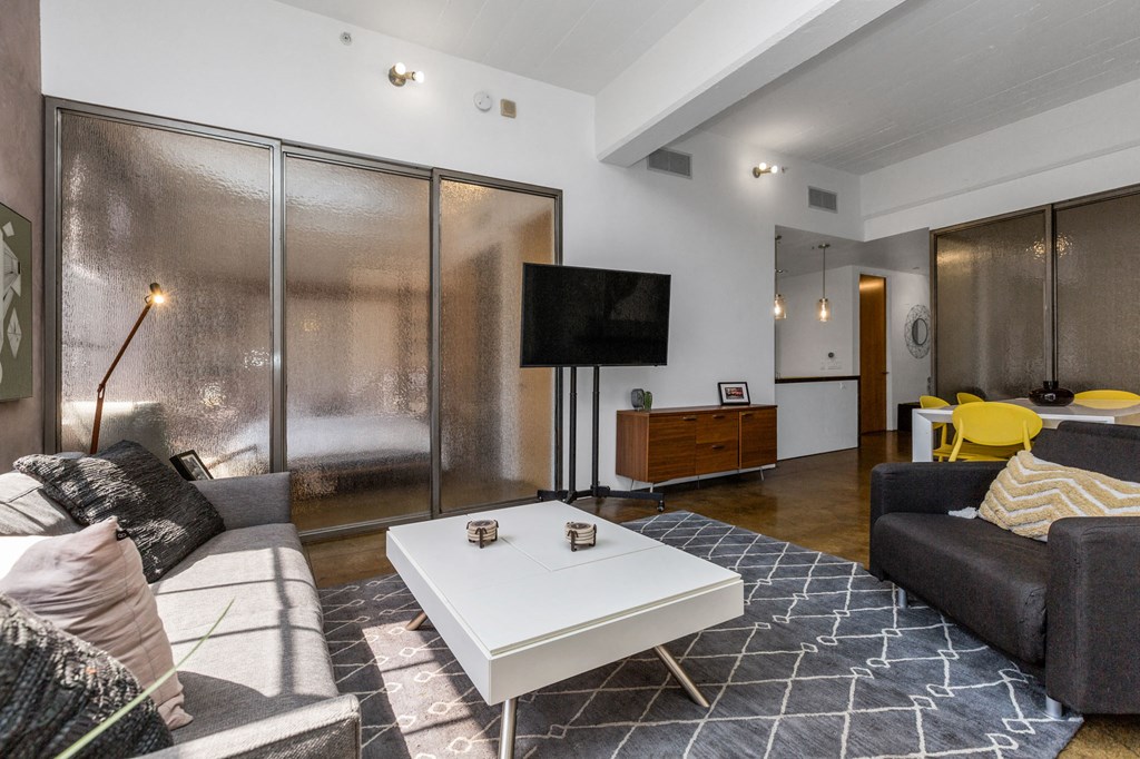 a living room with a couch and a coffee table and a television