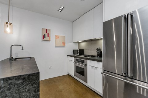 a kitchen with stainless steel appliances and a stainless steel refrigerator