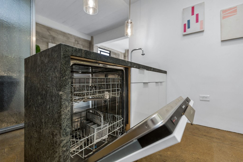 a dishwasher in a kitchen next to a stairs