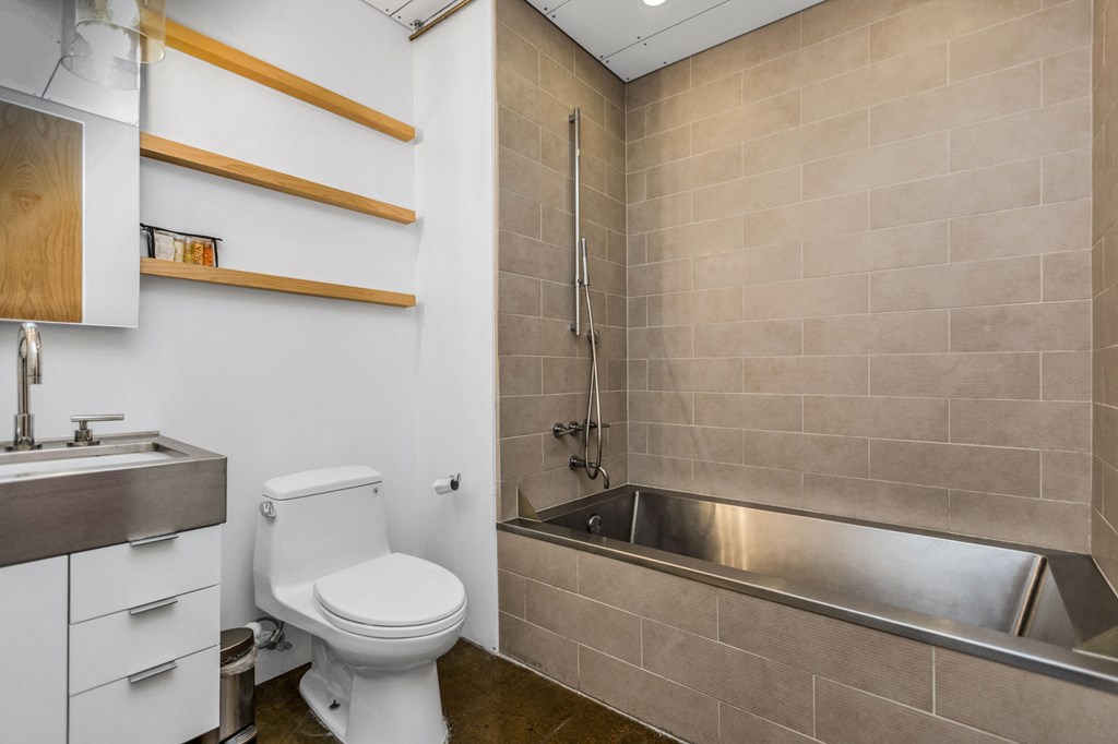 a bathroom with a toilet and a tub and a sink