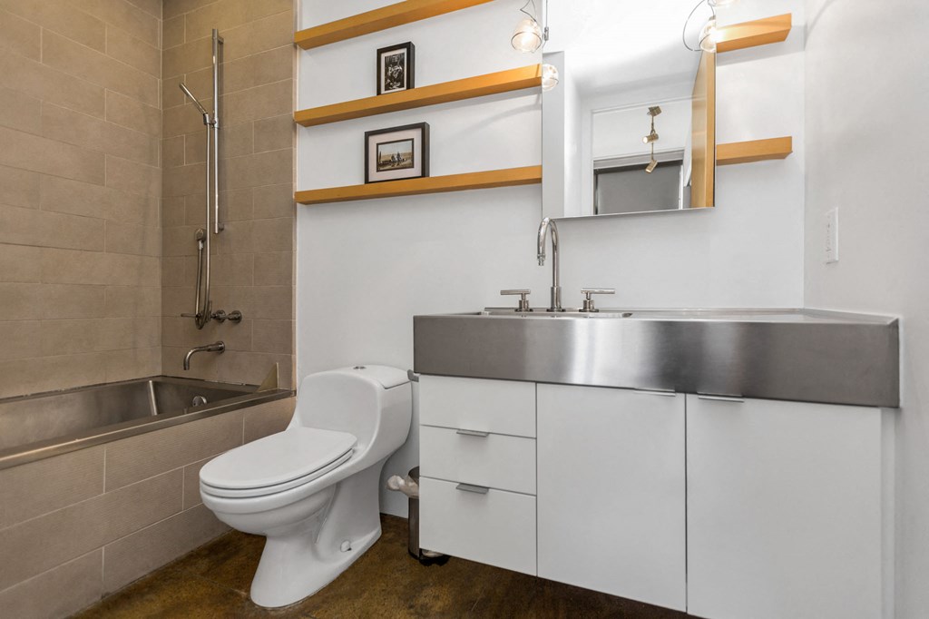 a bathroom with a toilet and a sink and a shower