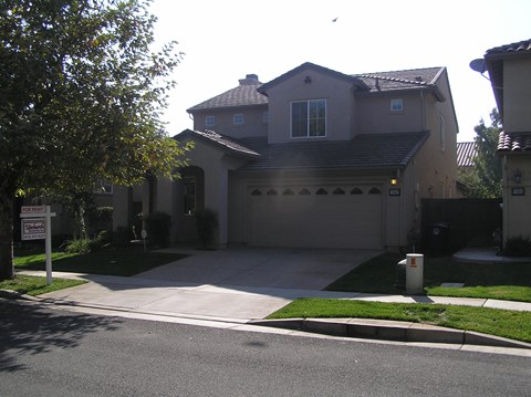 the front of a house with a driveway and a garage door