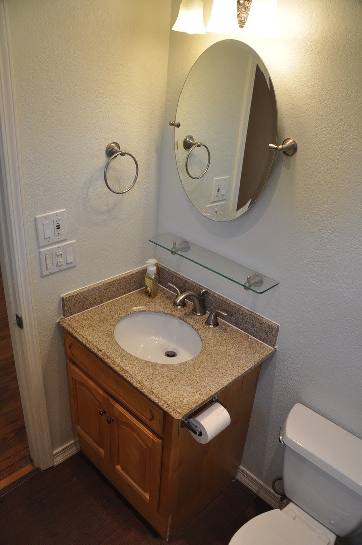 a bathroom with a sink and a mirror and a toilet