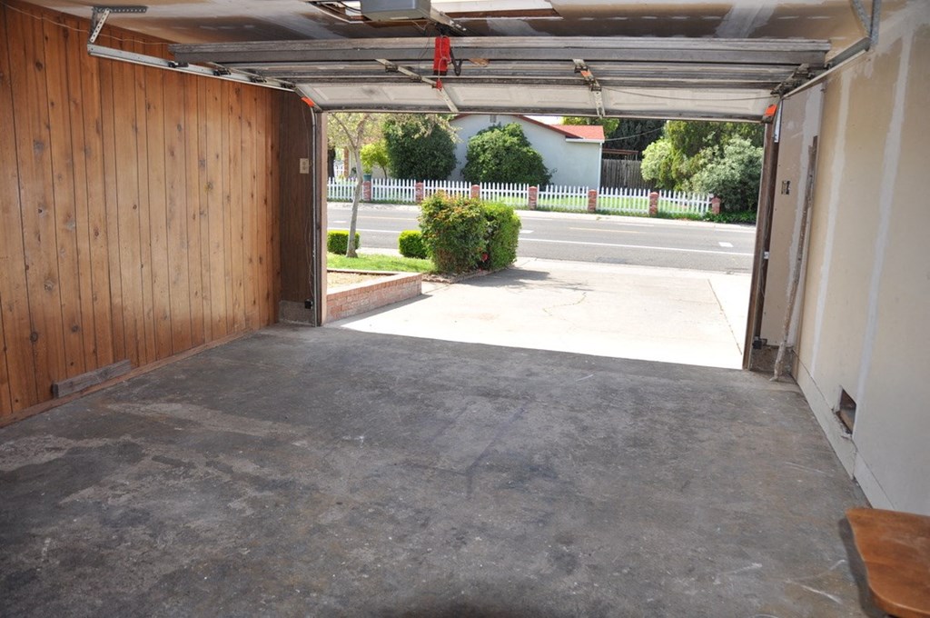 an empty garage with the door open
