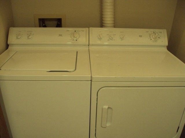 two white washes sitting next to each other