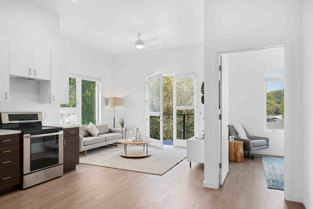 an open living room with a kitchen and a living room
