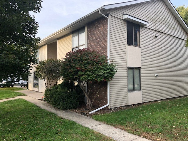 a white house with a sidewalk in front of it