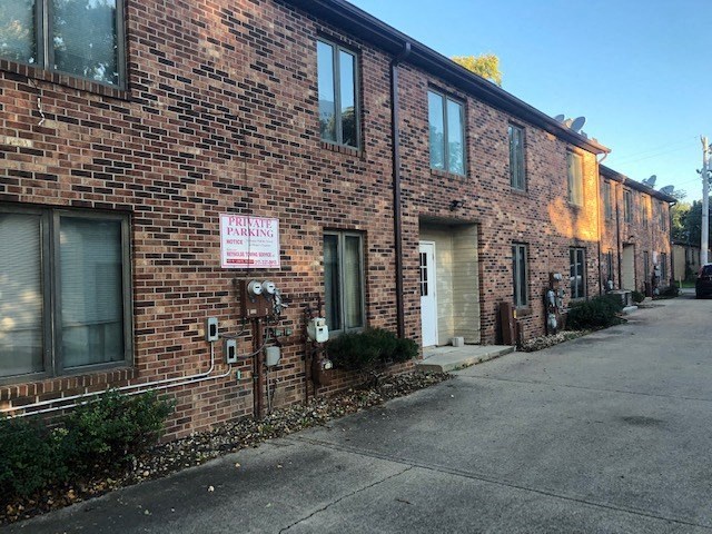 A brick building with a sign that says "Parking".