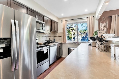 A kitchen with a large refrigerator and stainless steel appliances.