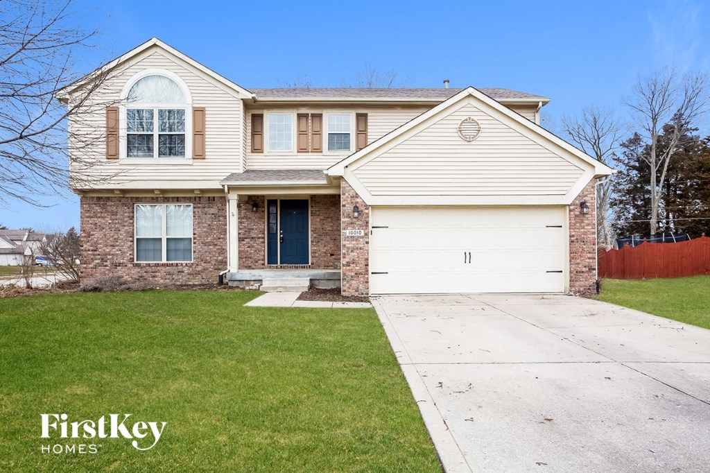 A two-story house with a garage is for sale.