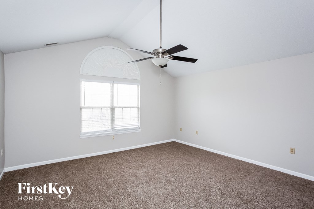 A room with a fan and a window.