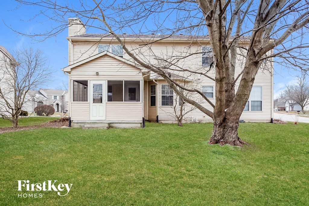 A house with a tree in front of it.