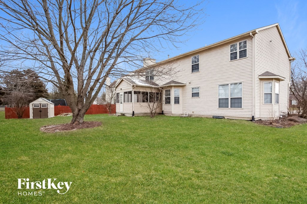 A house with a tree in front of it.