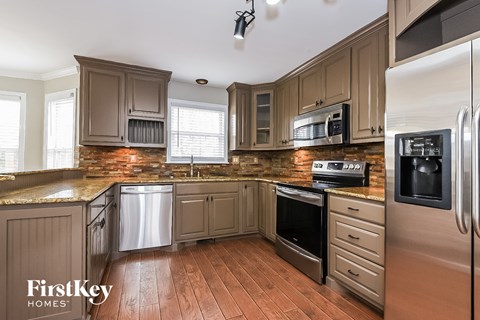 A kitchen with wooden cabinets and stainless steel appliances.