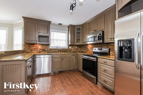 A kitchen with wooden cabinets and stainless steel appliances.