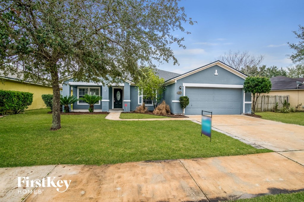 A house with a blue garage door is for sale.
