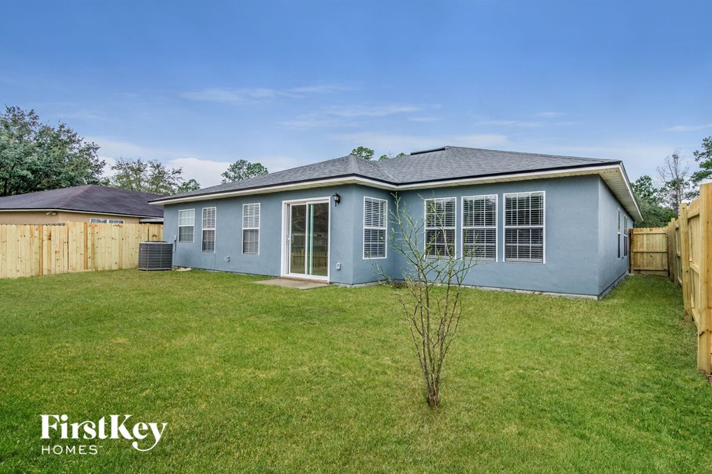 A blue house with a tree in front of it.