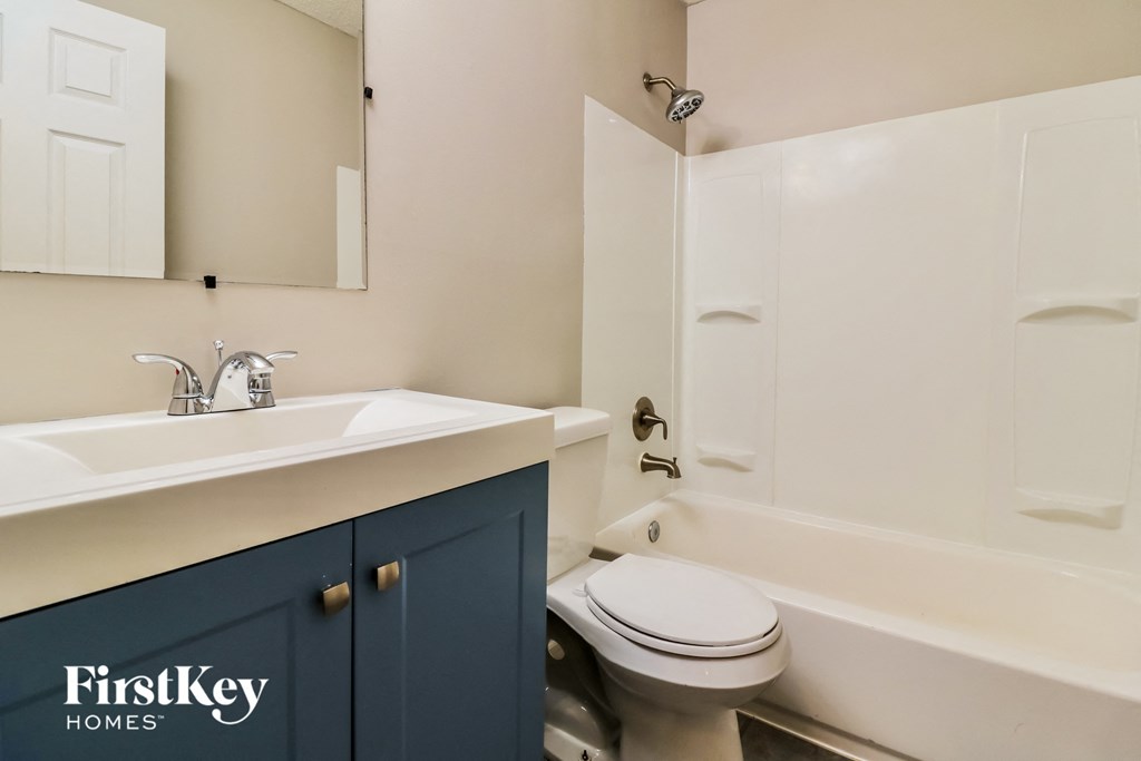 a bathroom with a sink toilet and bath tub