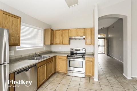 A kitchen with wooden cabinets and stainless steel appliances.