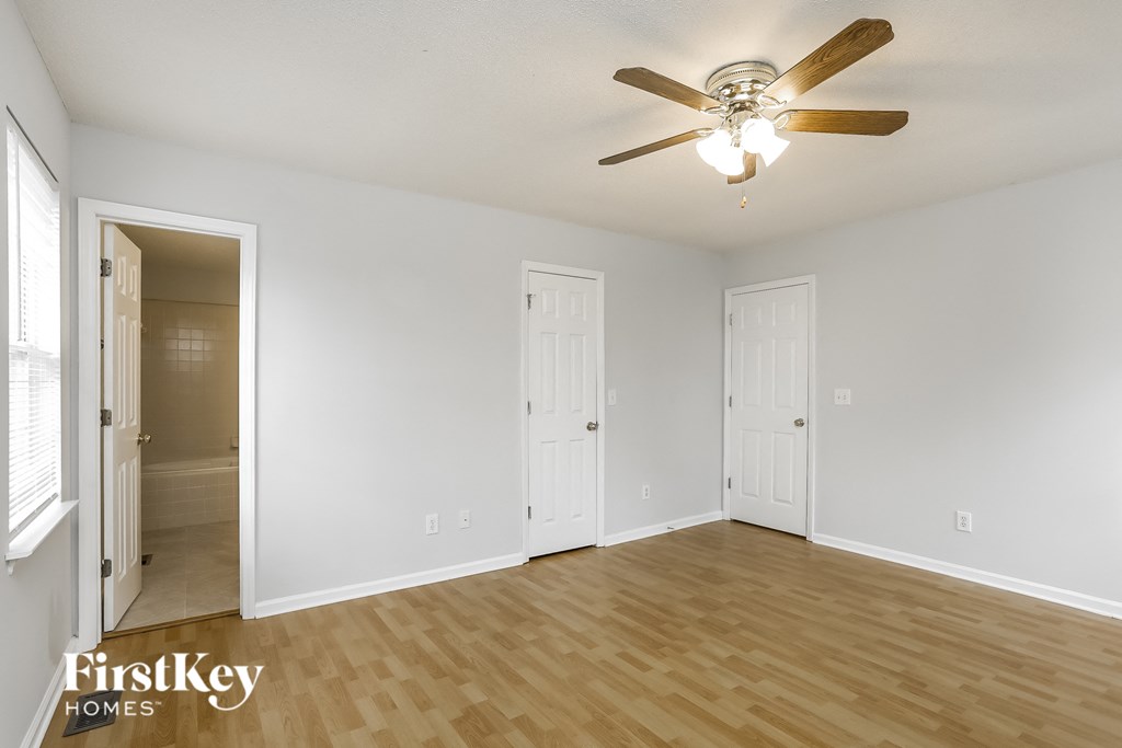 a living room with wood flooring and a ceiling fan