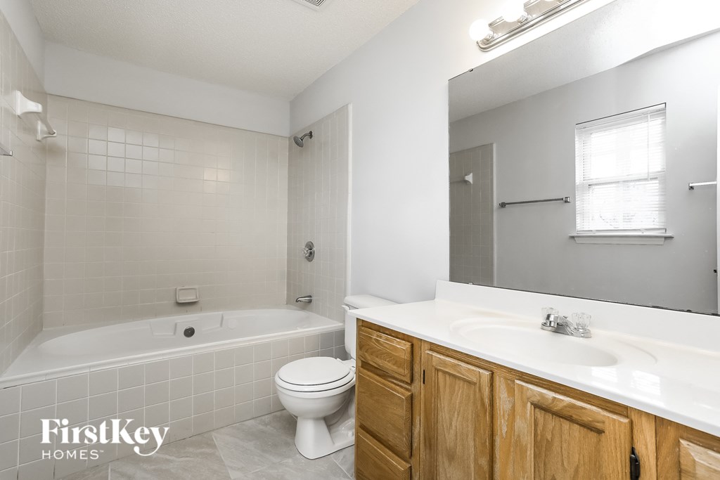 a bathroom with a sink toilet and a bath tub
