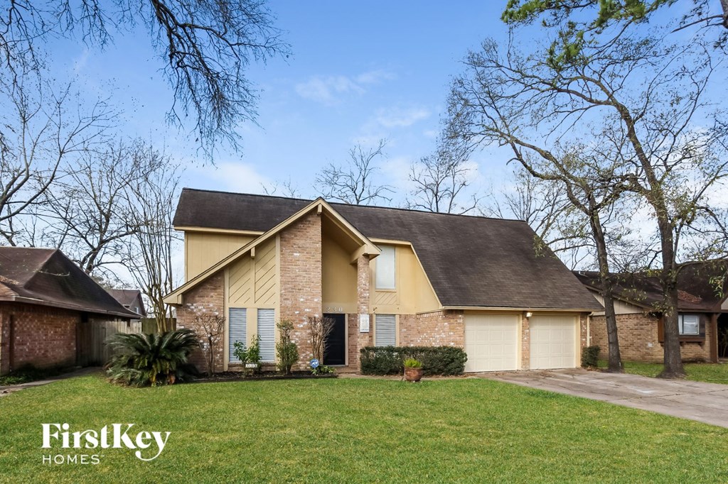 A house with a brown roof and a white garage door is for sale.